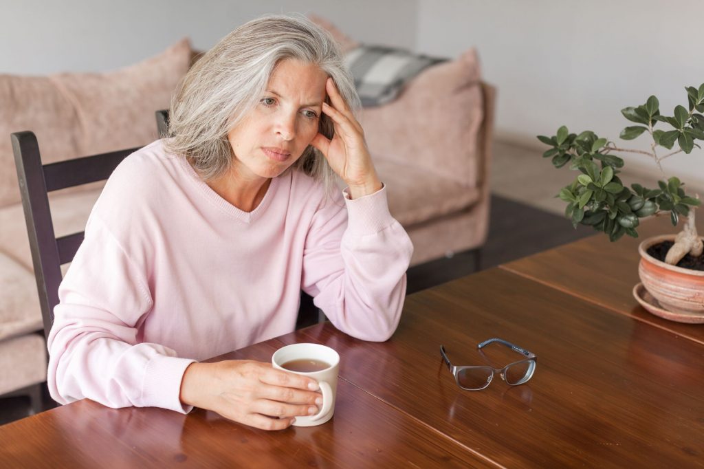 stressed lonely woman with coffee after saying "they're fine"
