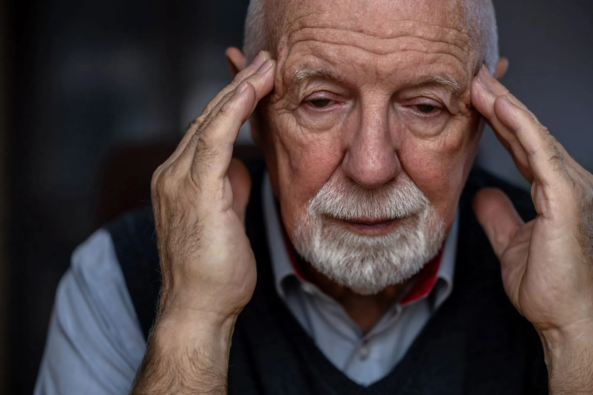 close up of a senior man with white hair and white beard, hands on head, confused, depressed, possibly dementia or alzheimer's