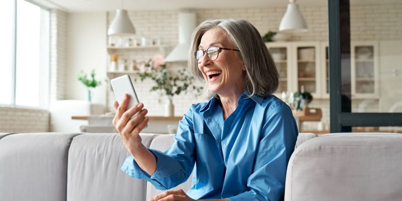 older adult woman using phone