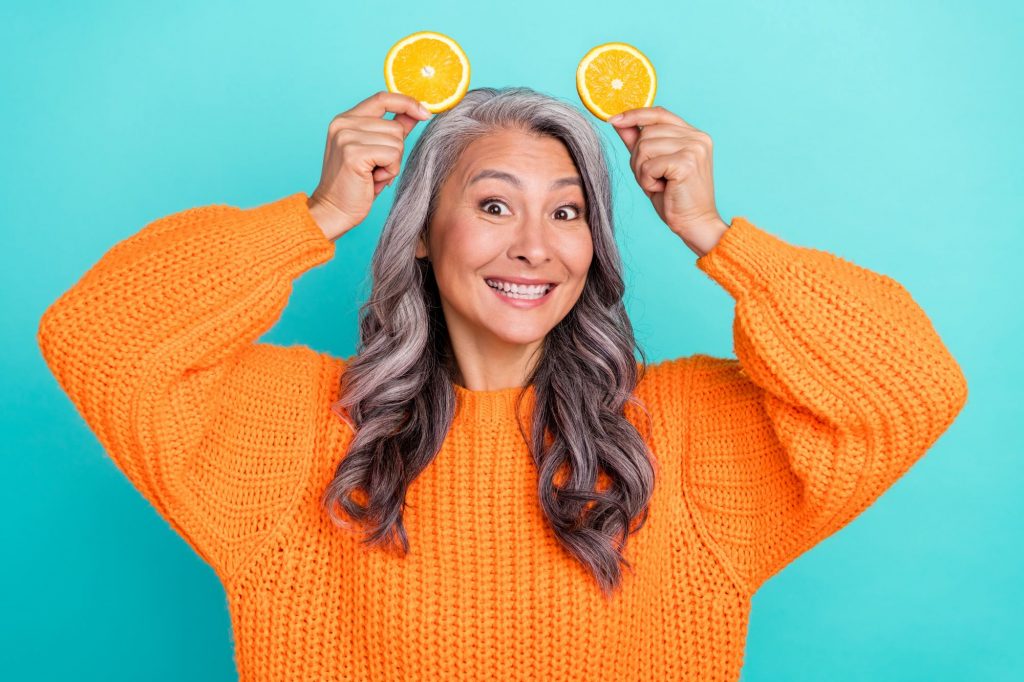 lady holding little orange slices