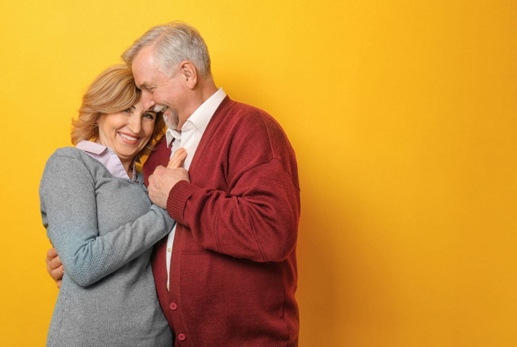 senior couple with a yellow background