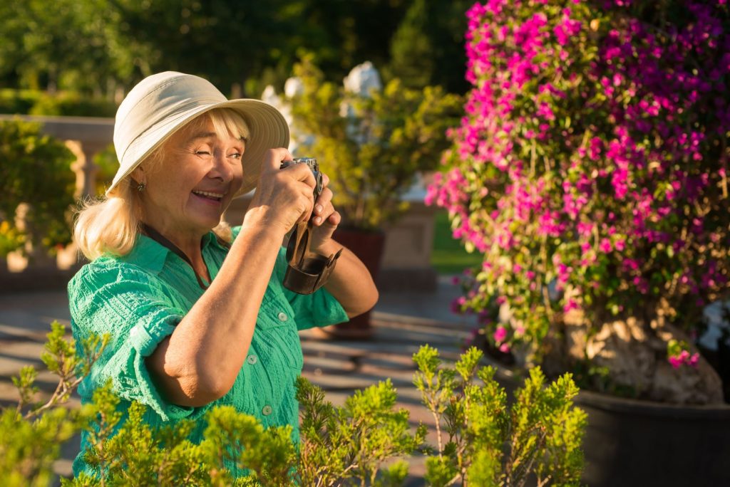 woman in garden taking photo