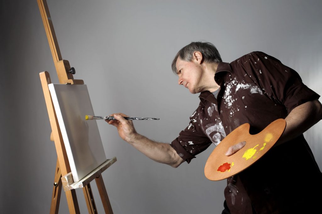 Baby Boomer artist painting a canvas