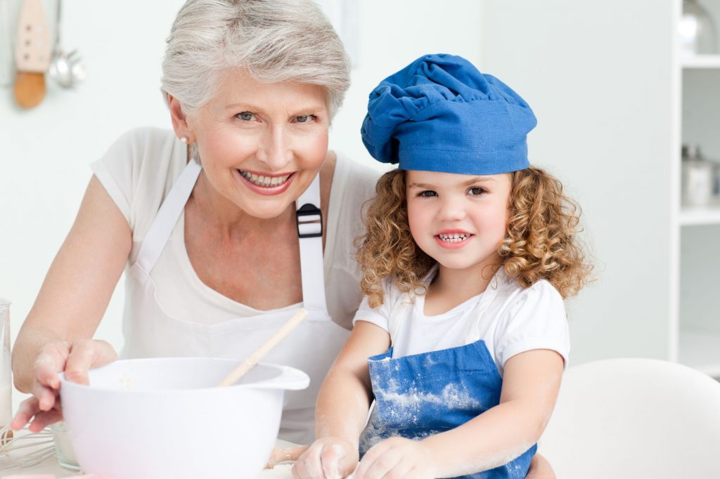 grandmother and granddaughter baking together