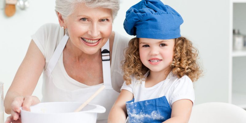 grandmother and granddaughter baking together