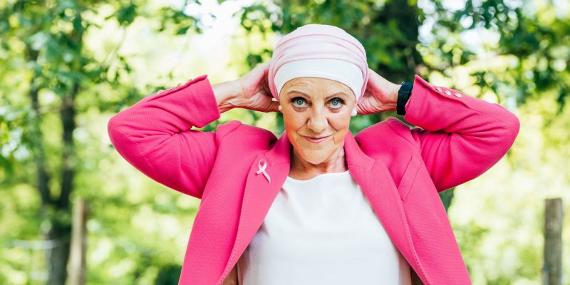 woman with breast cancer wearing a pink jacket
