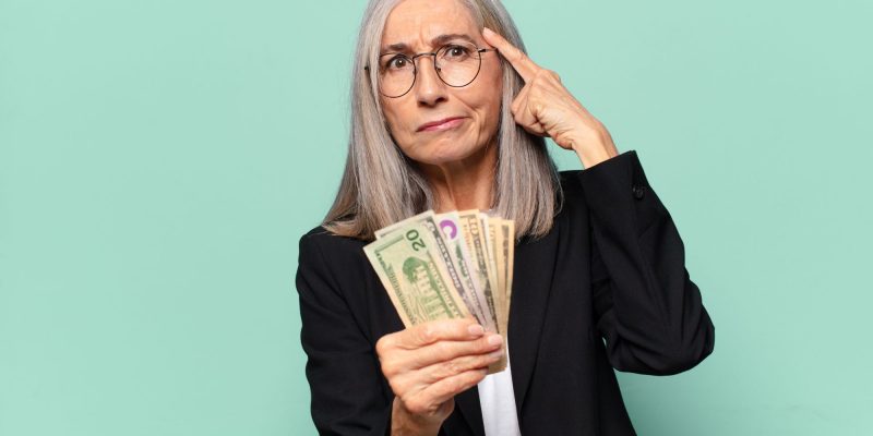 thinking with money in hands