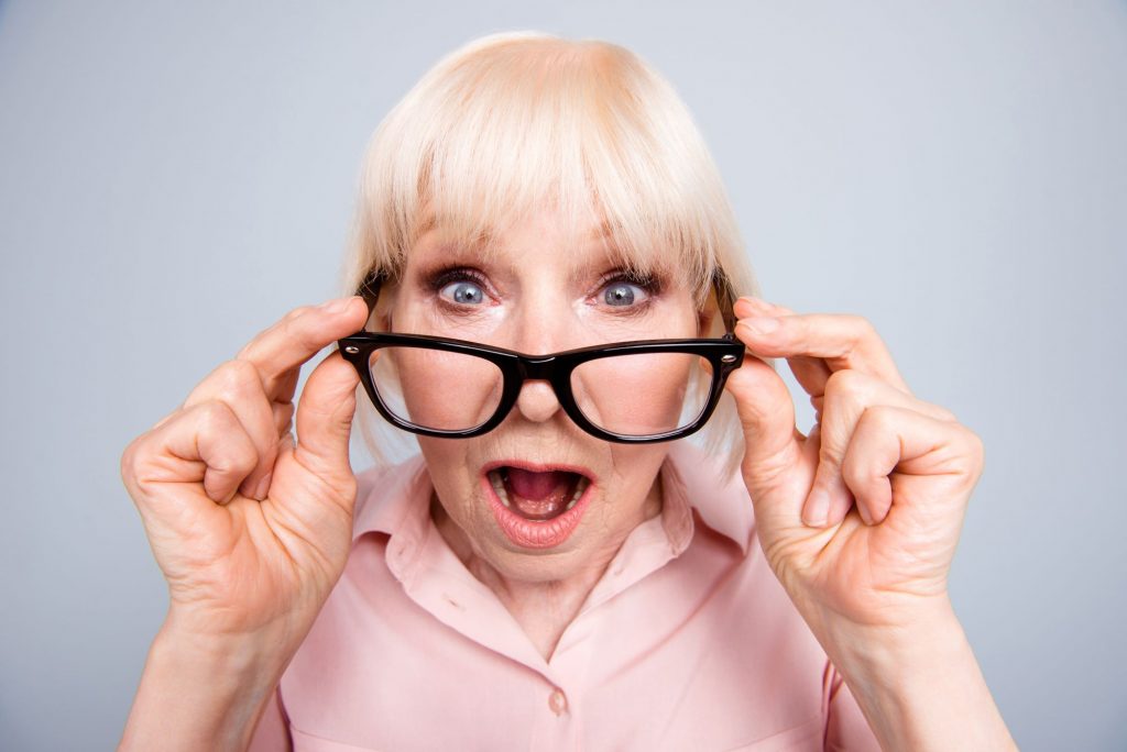 shocked senior woman wearing glasses
