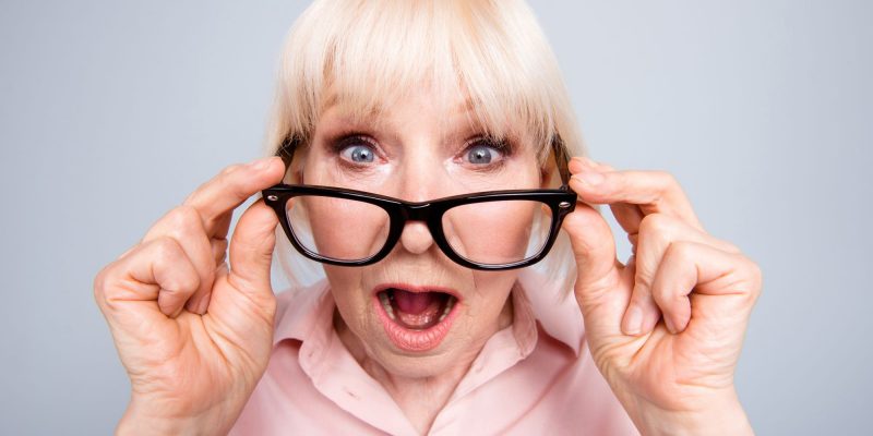 shocked senior woman wearing glasses