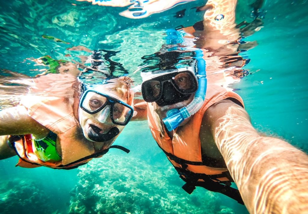 snorkeling couple under water