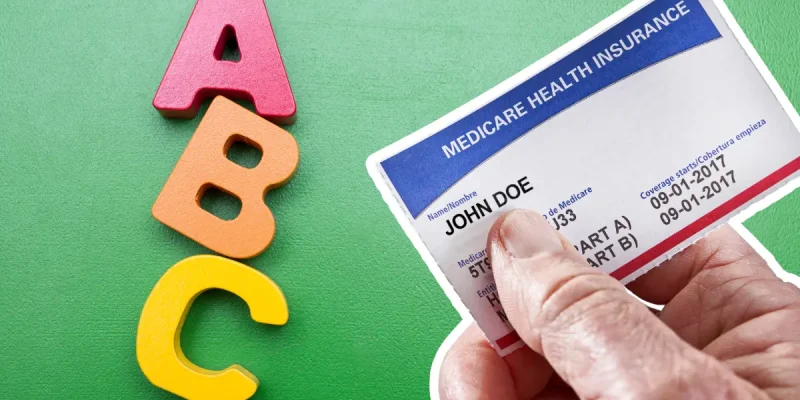 ABC letters and a John Doe medicare card being held by a male hand
