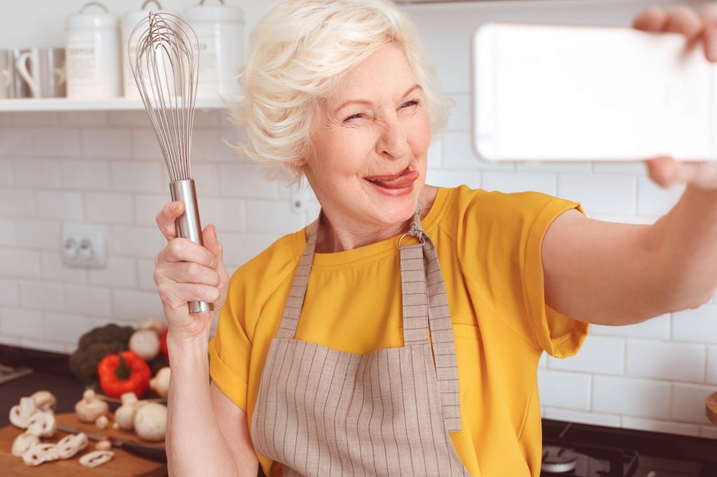 cooking with a whisk and taking a selfie