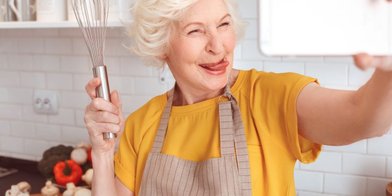 cooking with a whisk and taking a selfie