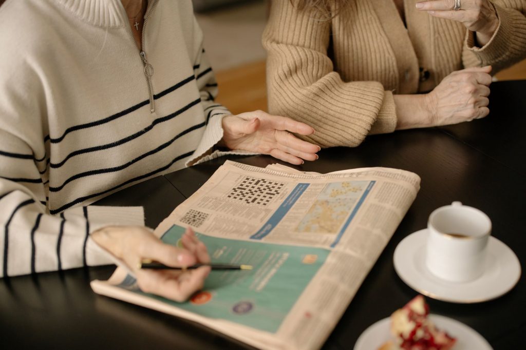 crossword puzzle on table near coffee cup