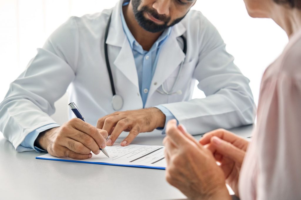 doctor and patient discussing medicare-approved services at a hospital