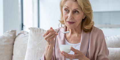 senior woman eating yogurt