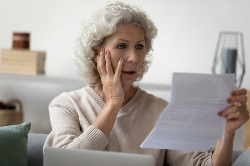 lady clasping paper and shocked