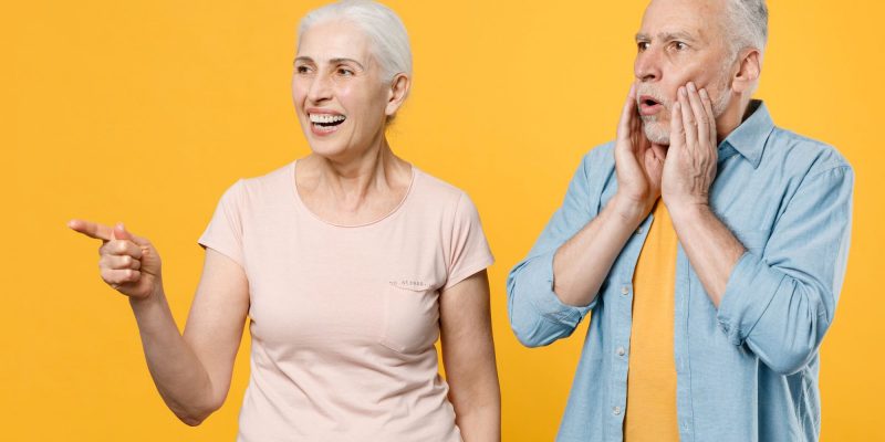 pointing couple with yellow background