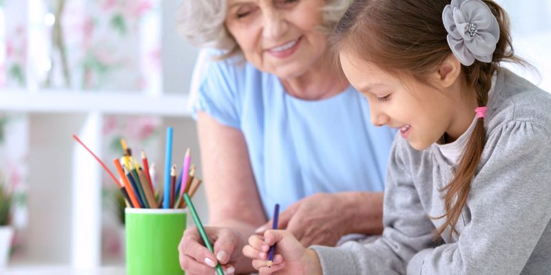 grandma and girl with pigtails drawing together