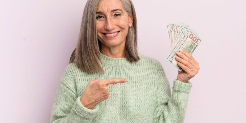 happy senior woman with money