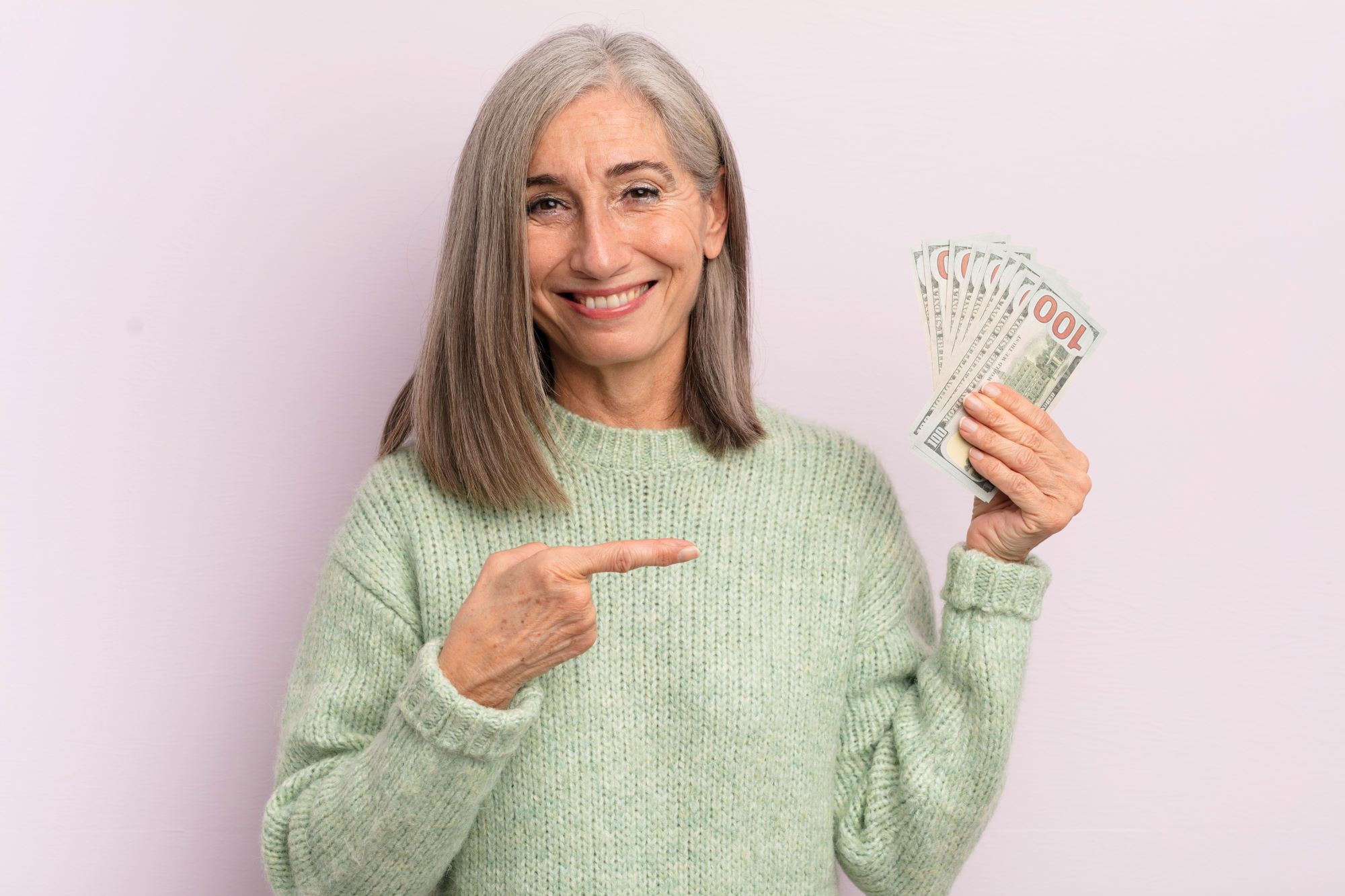 happy senior woman with money