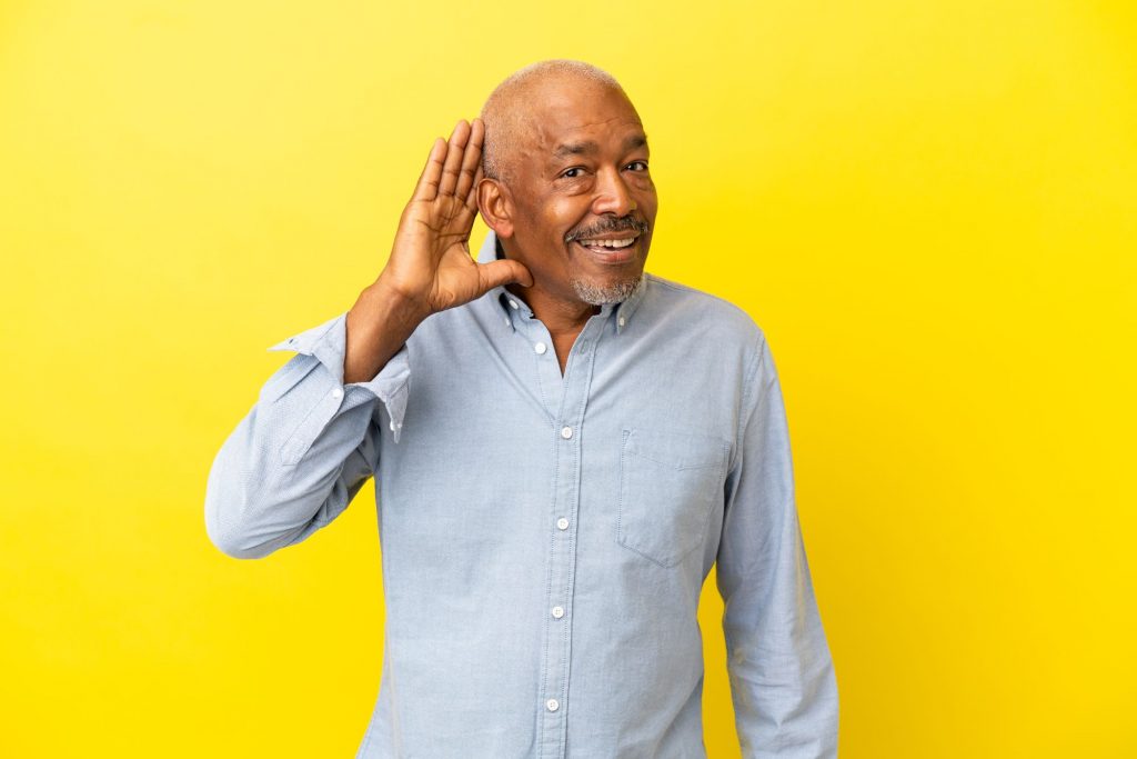 hearing man with yellow background