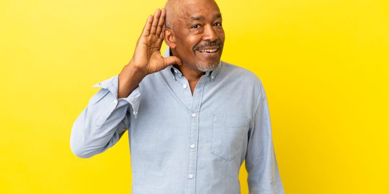 hearing man with yellow background