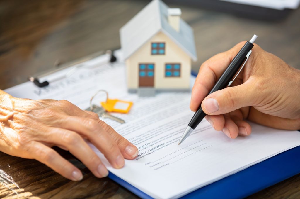 hand signing real estate documents, realtor
