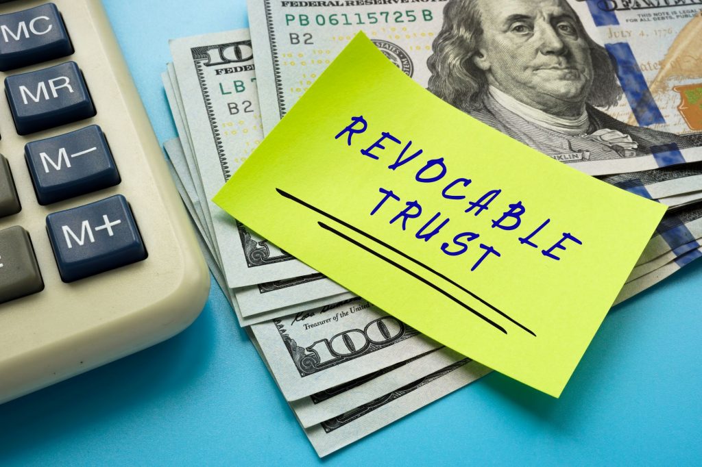 revocable trust words on top of a stack of money