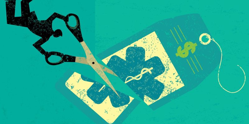 Cutting Health Care Costs A businessman cutting the high price of healthcare tag with large scissors over an abstract background.