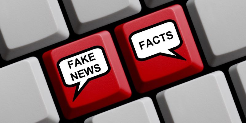fake news and facts on keyboard