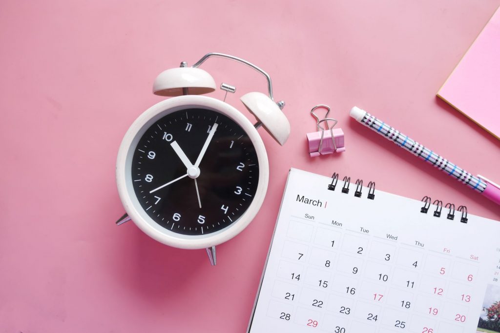 clock and pink planner