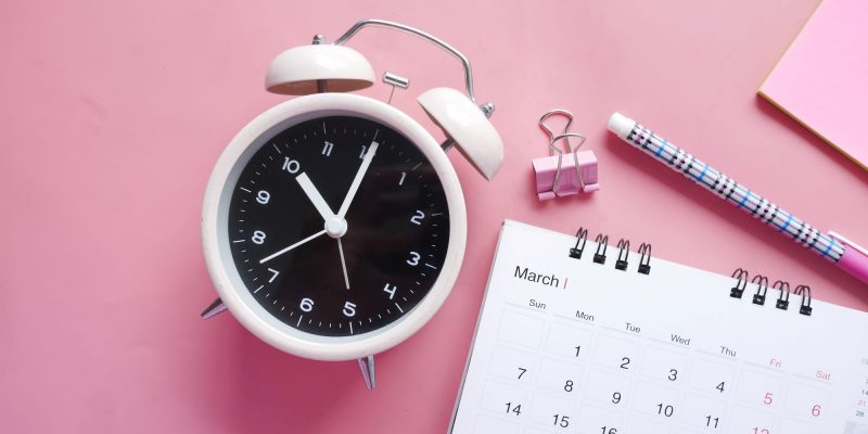 clock and pink planner
