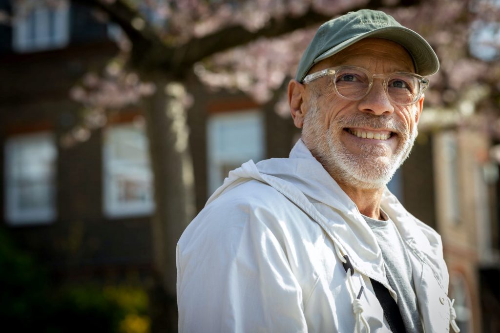 smiling senior man outside wearing a hat