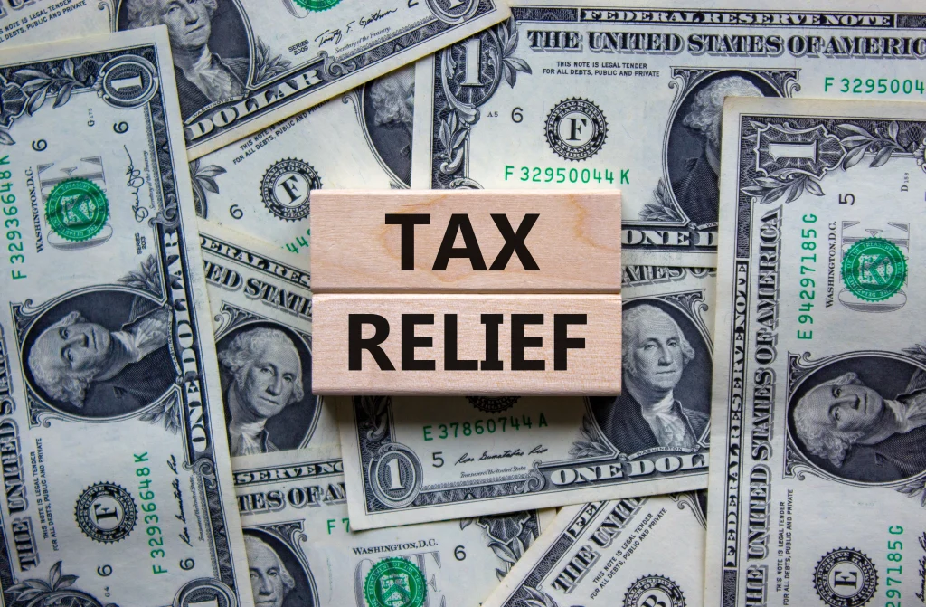 tex reflief words over a whole bunch of dollar bills