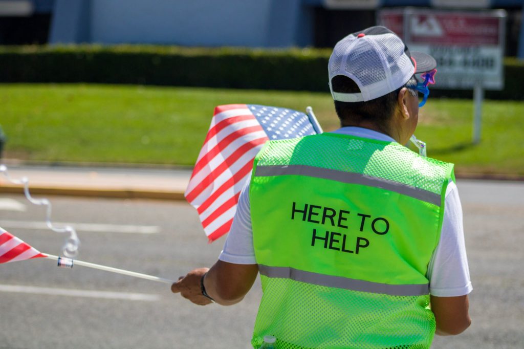 senior volunteer outside wearing a bright high vision vest