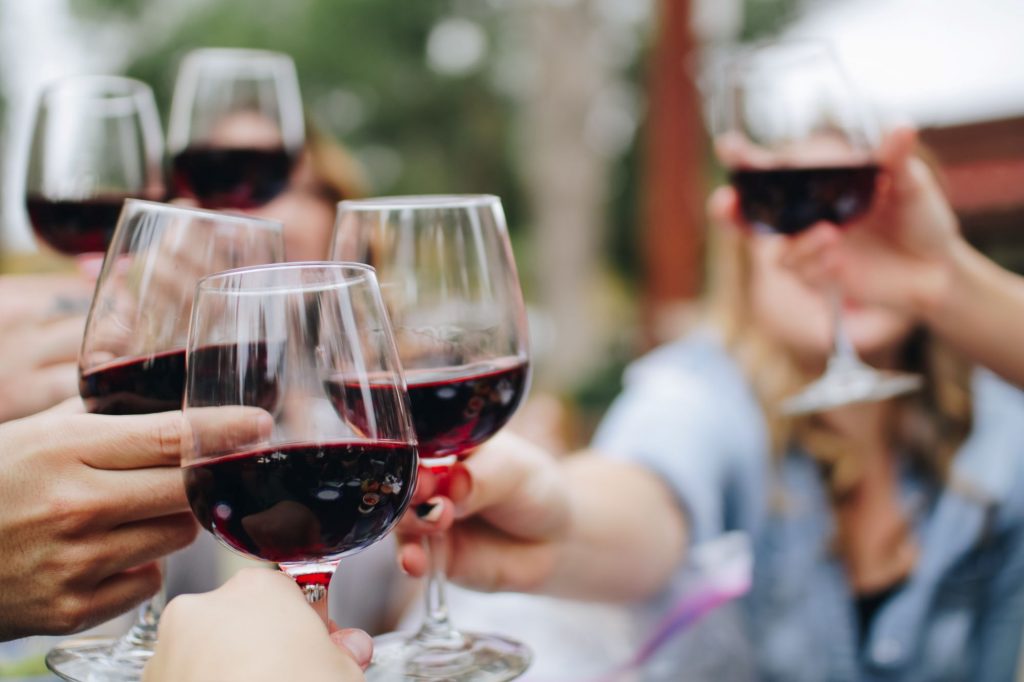 wine glasses doing cheers up close