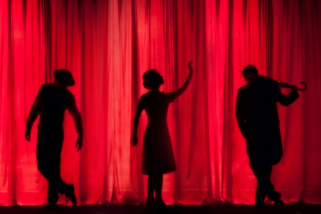 actors in front of a theater