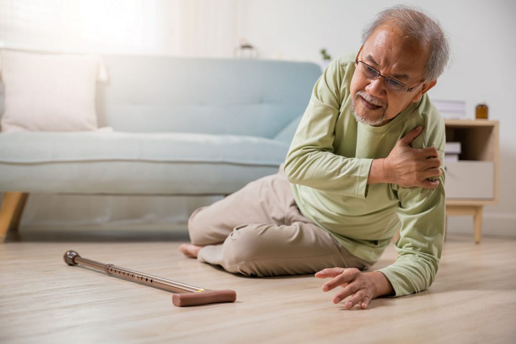 senior Asain man falling and hurting shoulder