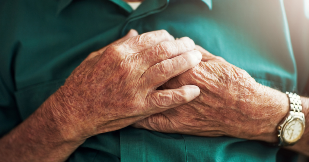 heart disease, shortness of breath, senior hands over a chest
