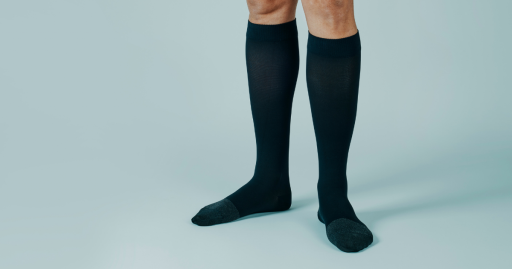 standing legs wearing knee high compression socks