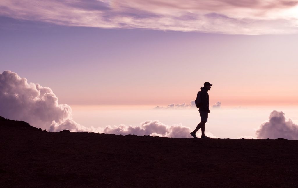 man walking along a mountain