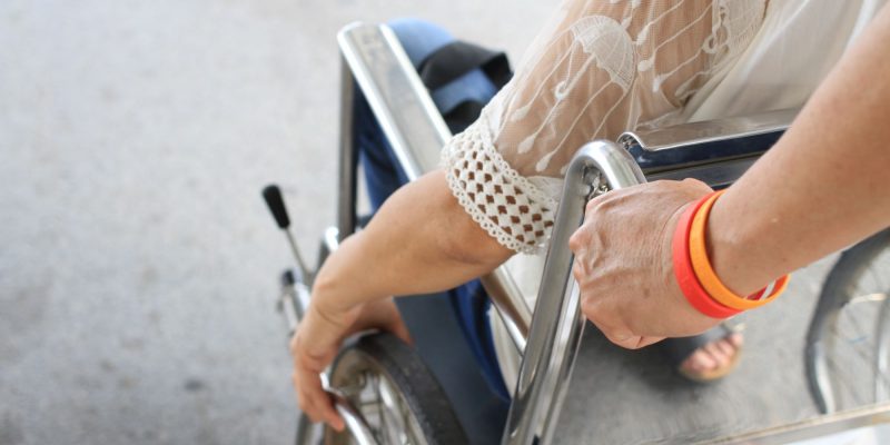 medical escort pushing a wheelchair