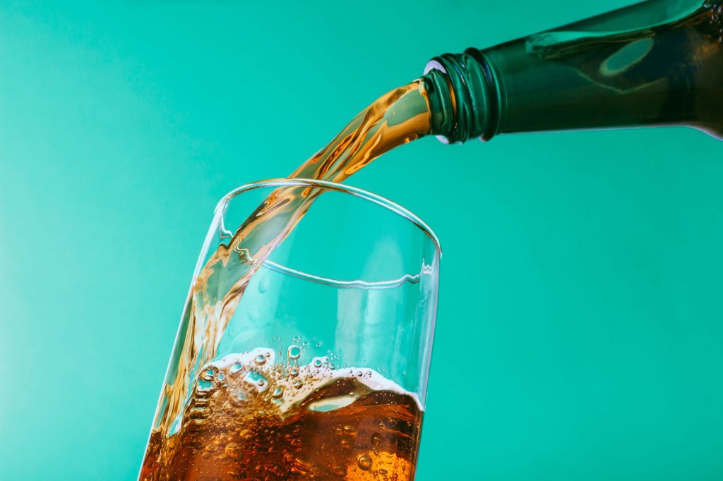 pouring soda into glass