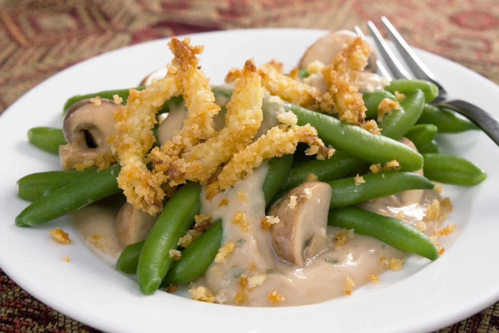 Green bean casserole - a traditional Thanksgiving side dish. Green beans with cream of mushroom soup and topped with french-fried onions.