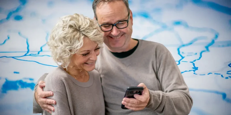 long distance grandparents on a video call with grandchildren map in background