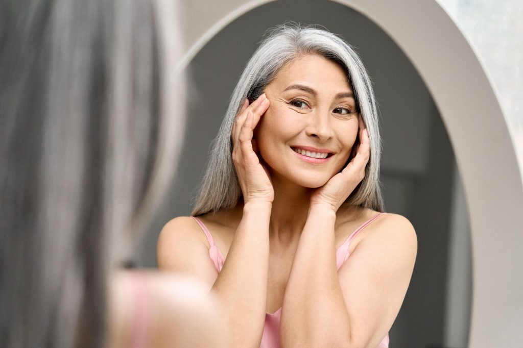 senior woman looking into a mirror