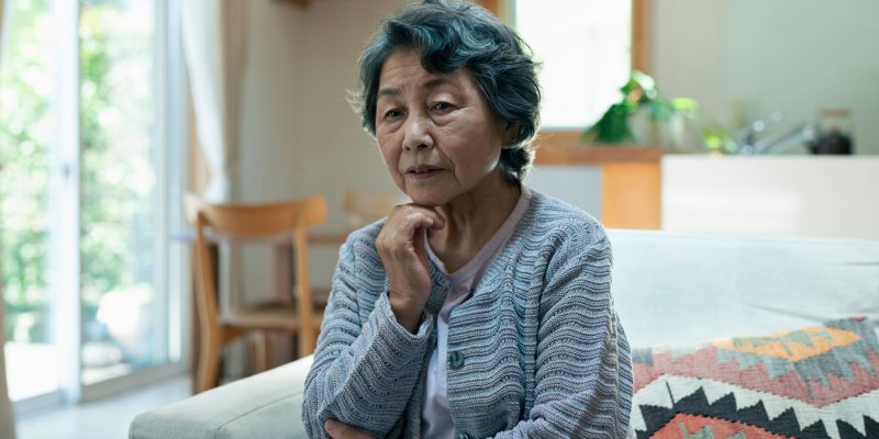 sad older asian woman