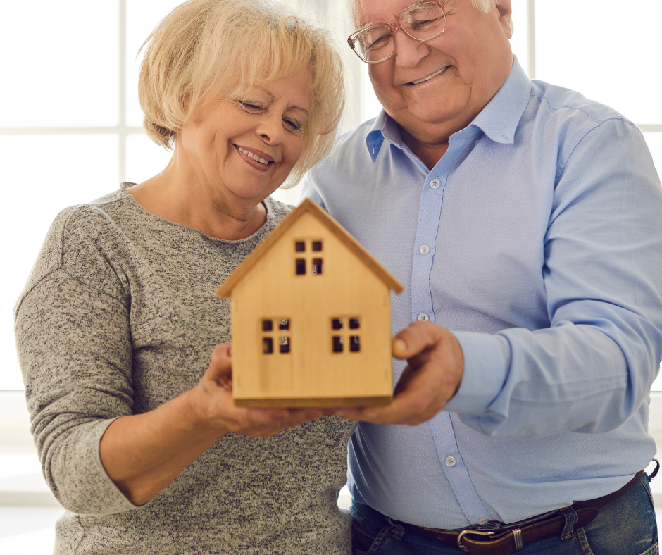 seniors holding a house symbolizing aging in place