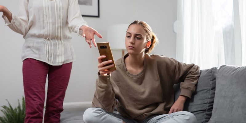 teen on phone ignoring grandparent